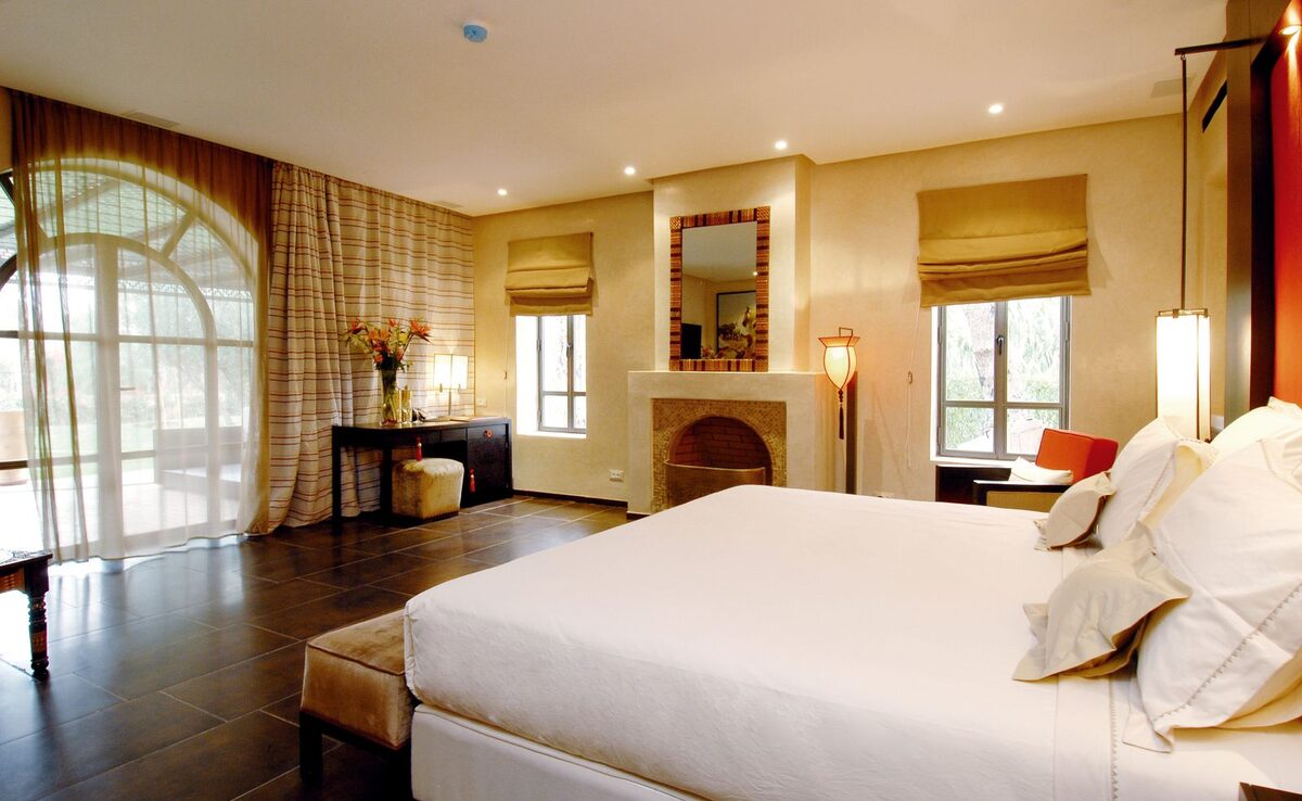 Elegant master bedroom suite with a king bed facing the horizon