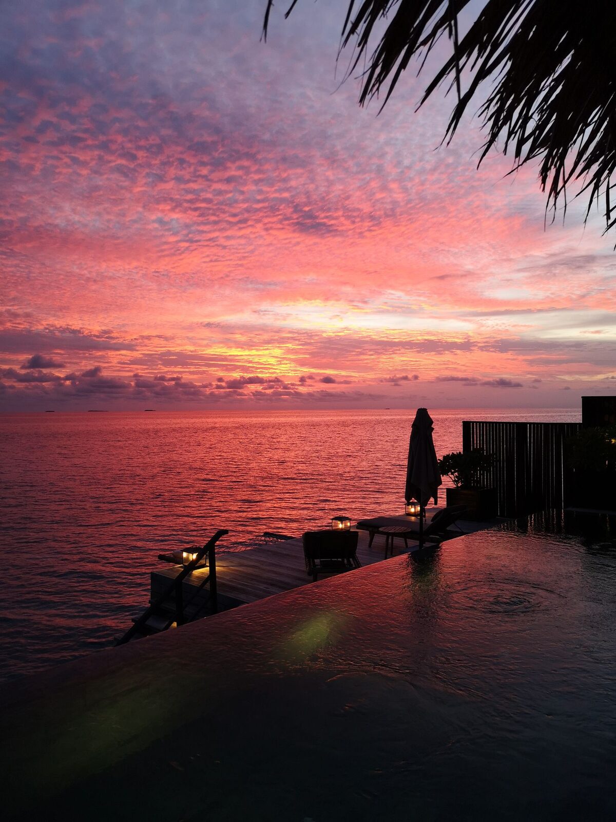 Deep orange sunset over the Andaman Sea seen from the villa terrace